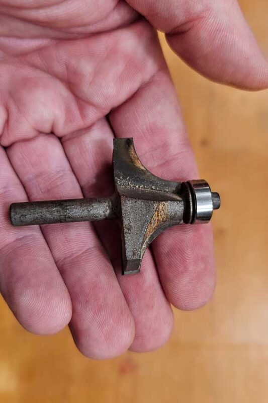 This router bit has too much resin on it and is starting to burn the wood. The solution it not to replace the bit. Instead, soak the bit with Pin Sol, then clean with a tooth brush.